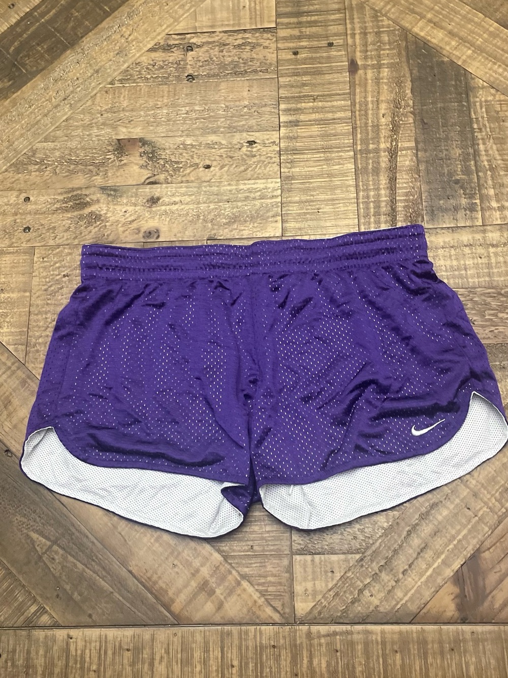 Nike Women's Training Mesh Shorts in purple with white accent lining.
